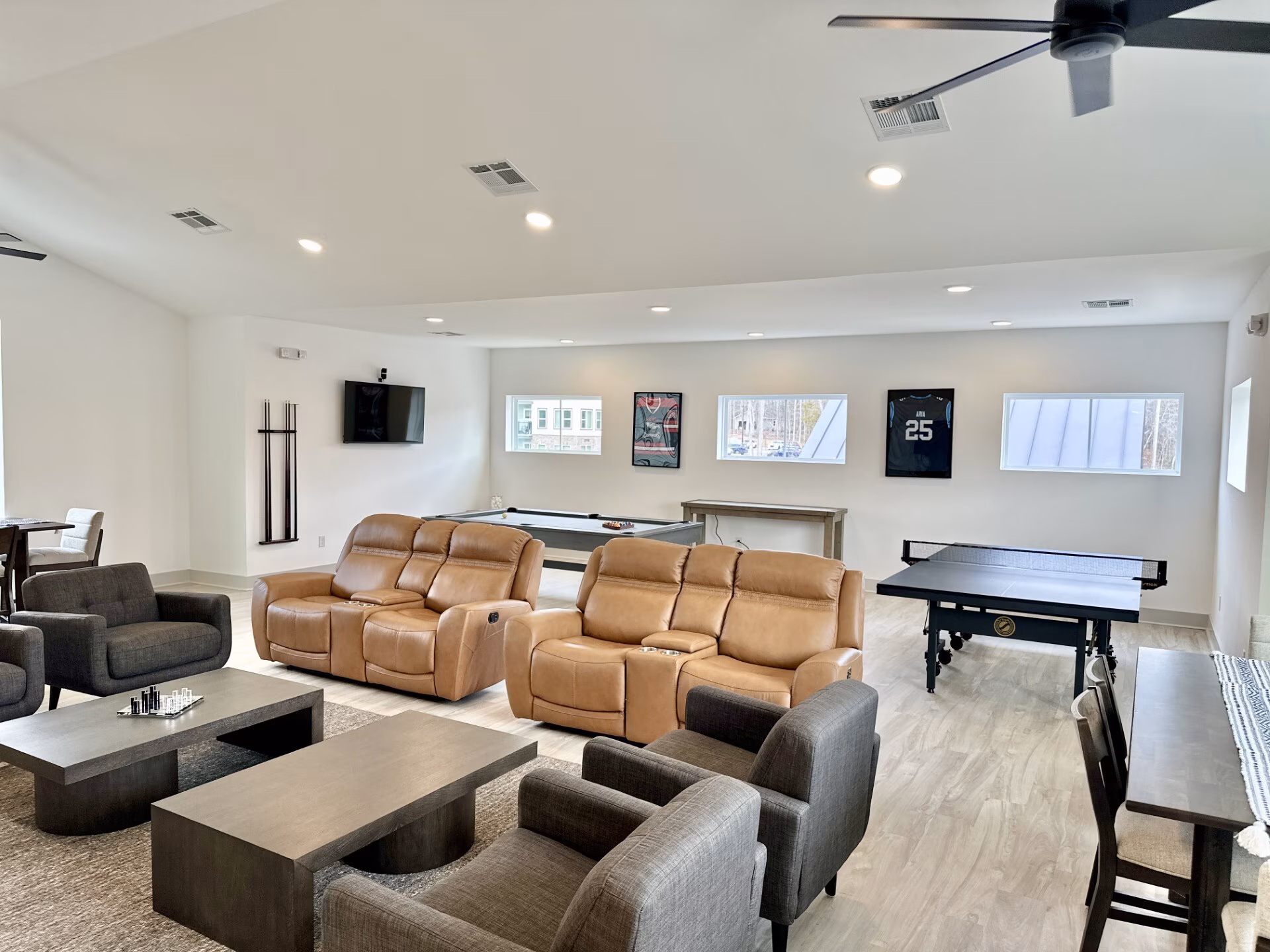 Game lounge with theater recliners and table tennis