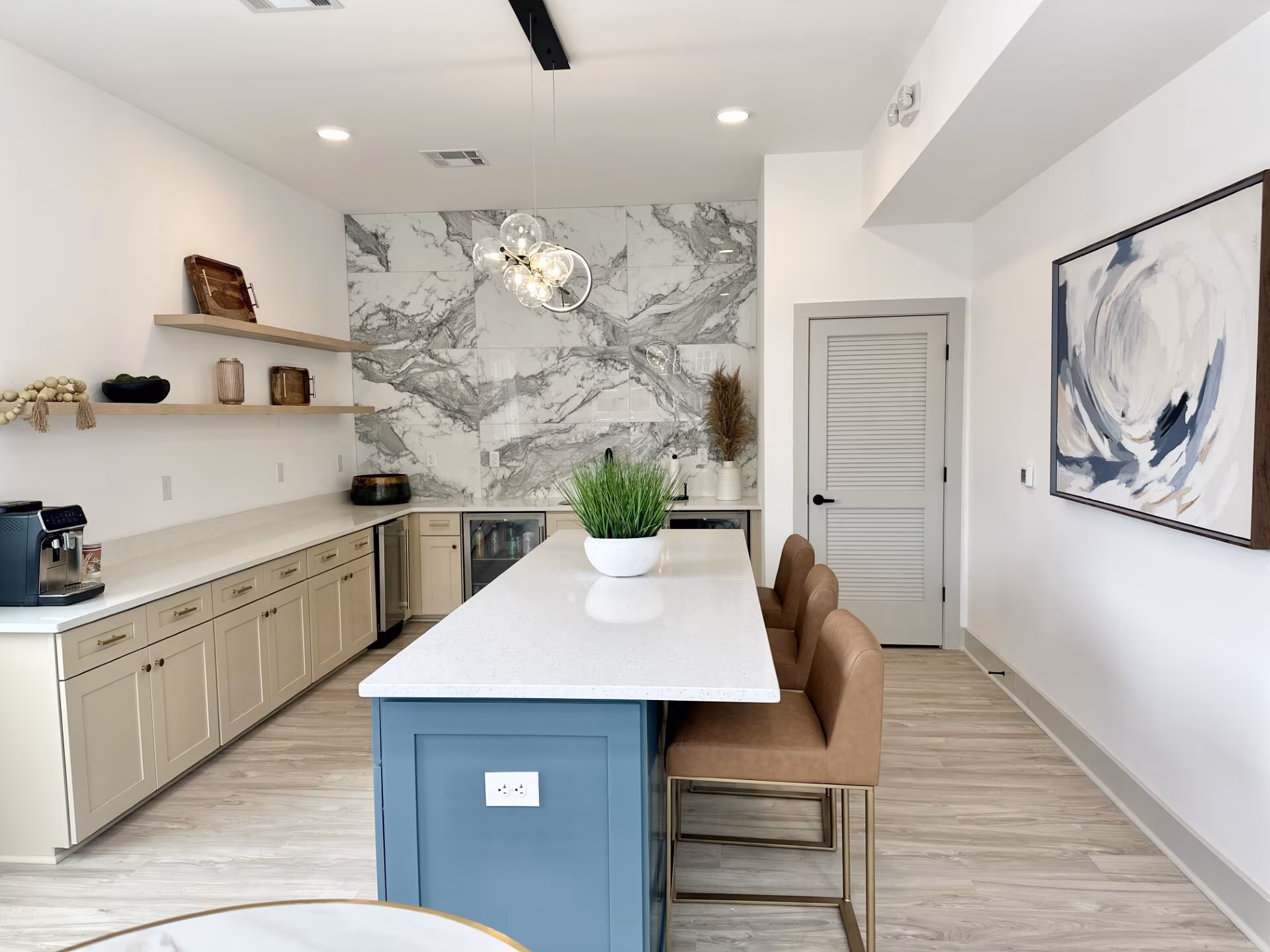 Clubhouse kitchen with an island and marble backsplash