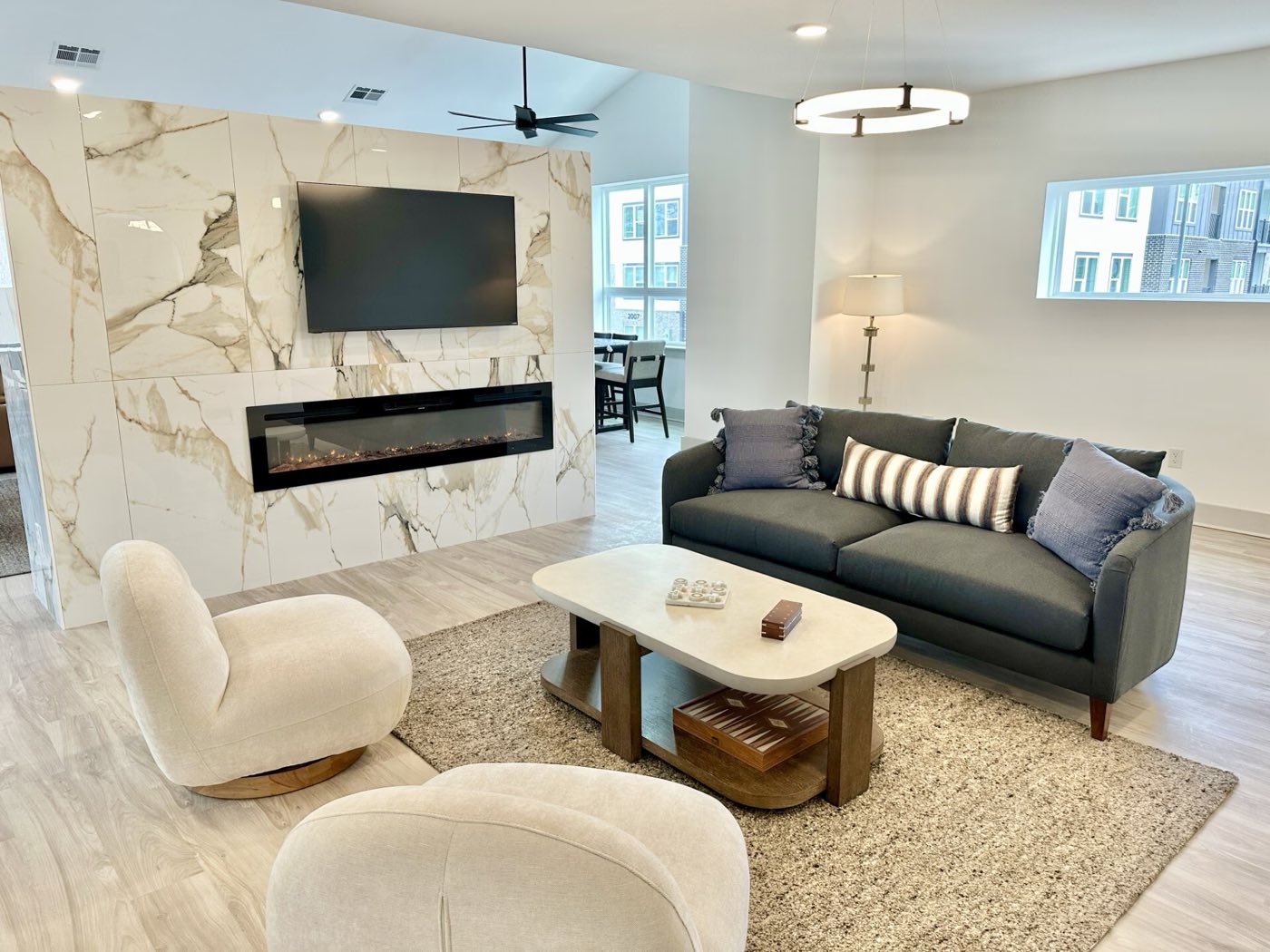 Clubhouse lounge with a linear fireplace in a marble surround