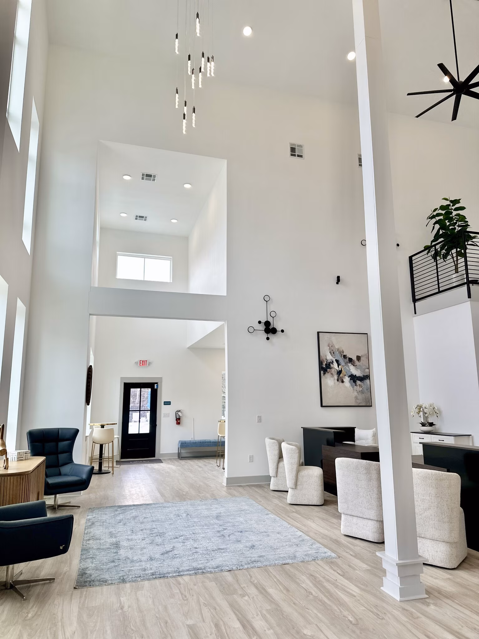 Double-height clubhouse lobby with a pendant chandelier