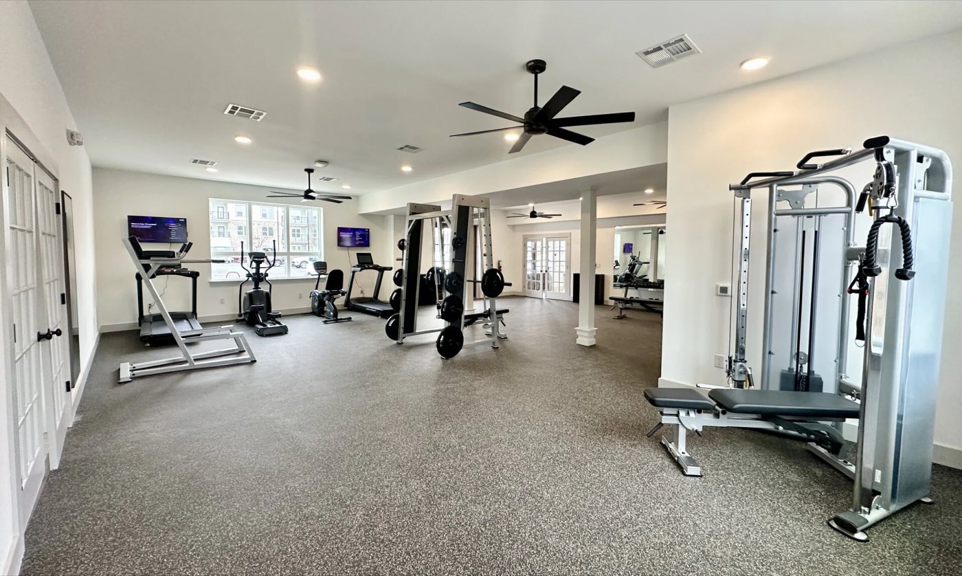 Fitness centre with cardio machines and a cable tower