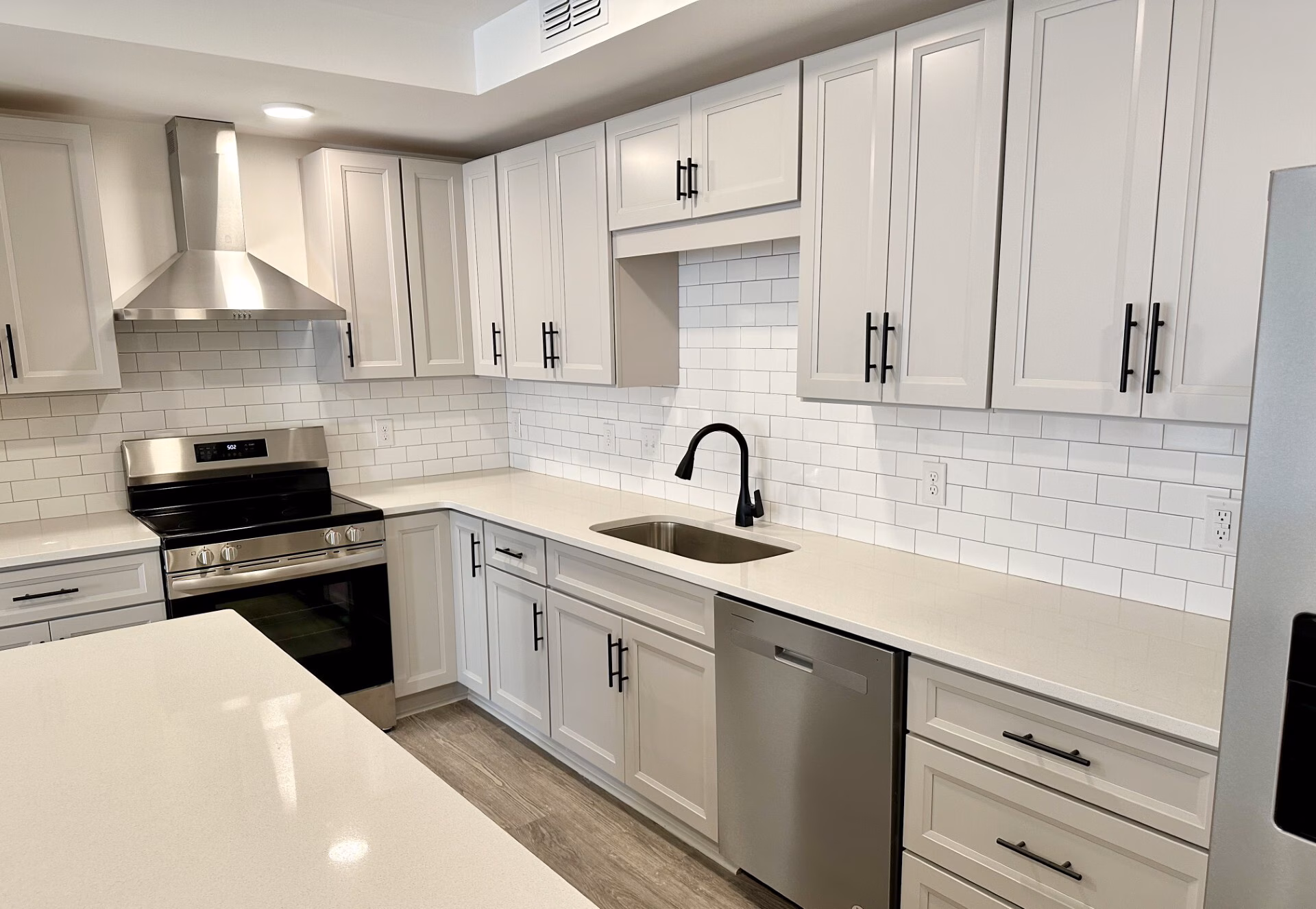 Kitchen with subway tile backsplash and stainless appliances