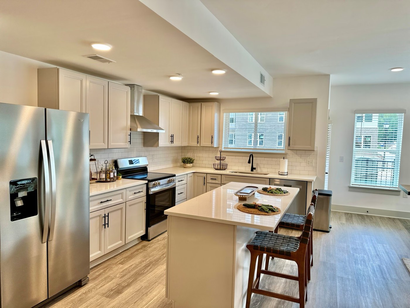 Open-concept kitchen and living room in a two-bedroom home at Aria at Idlewild