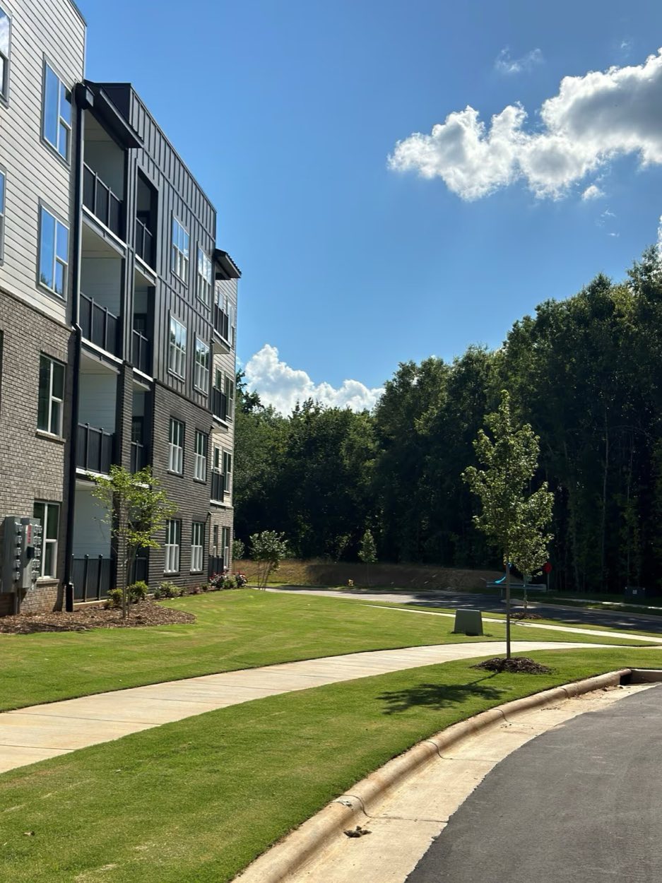 The greenway path running along the edge of the community